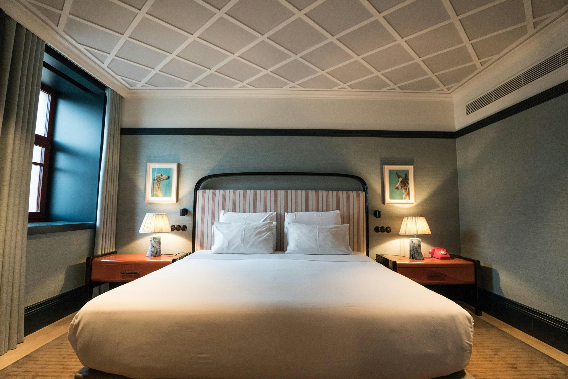 A large bed sitting in a bedroom next to a window